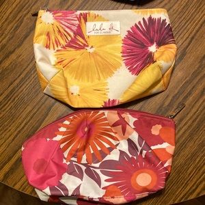 Two medium sized woman’s Clinique makeup bags